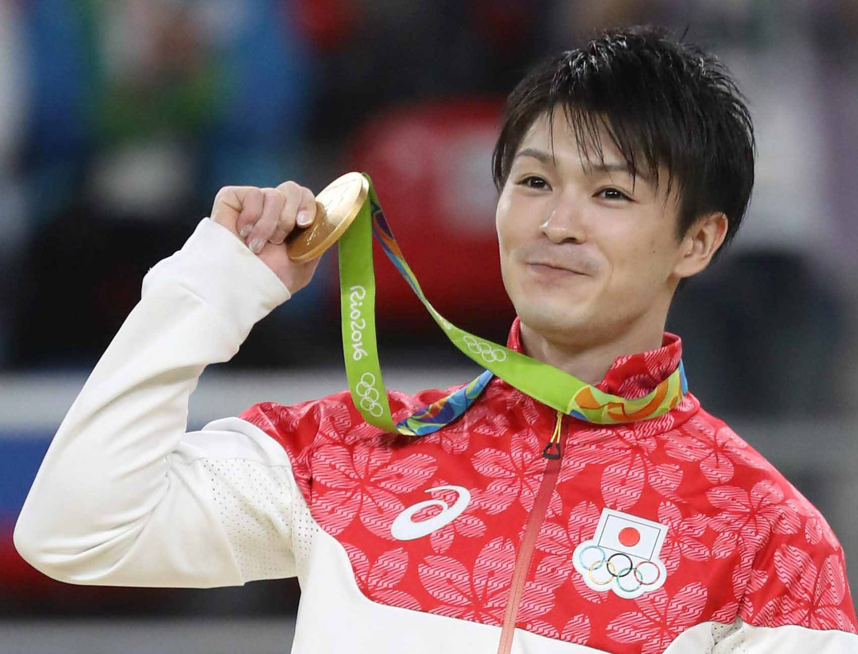 Uchimura holding a gold medal